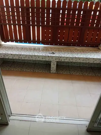 Charming balcony with tiled seating and wooden privacy fence