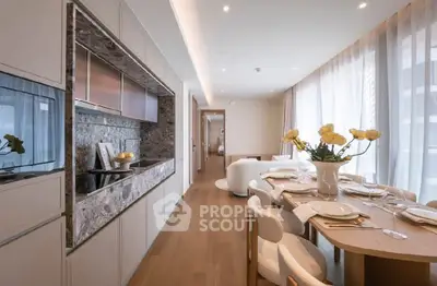 Luxurious open-plan kitchen and dining area with elegant decor and natural light.