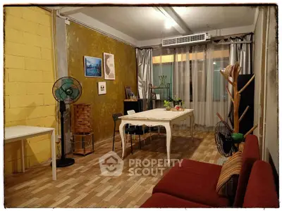 Charming living room with eclectic decor and vintage furniture, featuring a cozy ambiance and unique wall art.