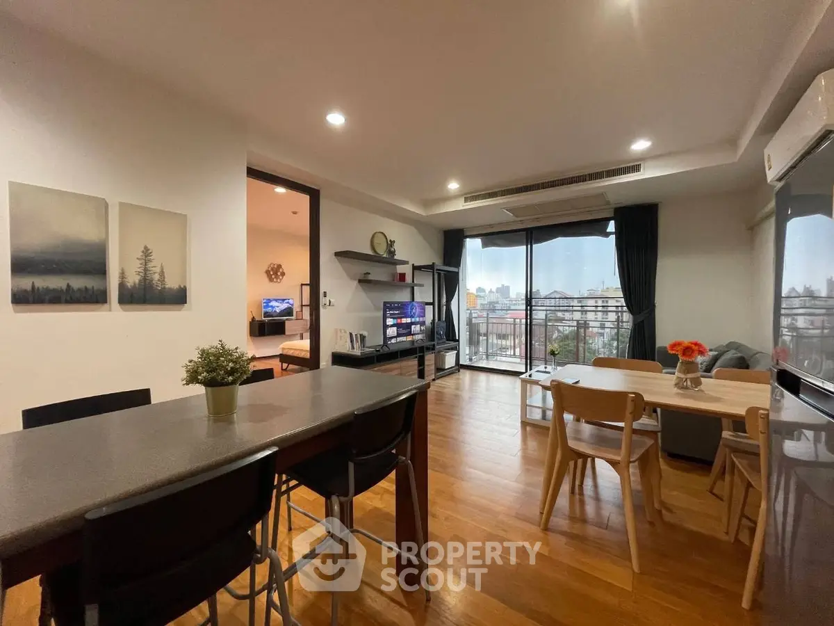 Spacious living room with modern decor and city view balcony