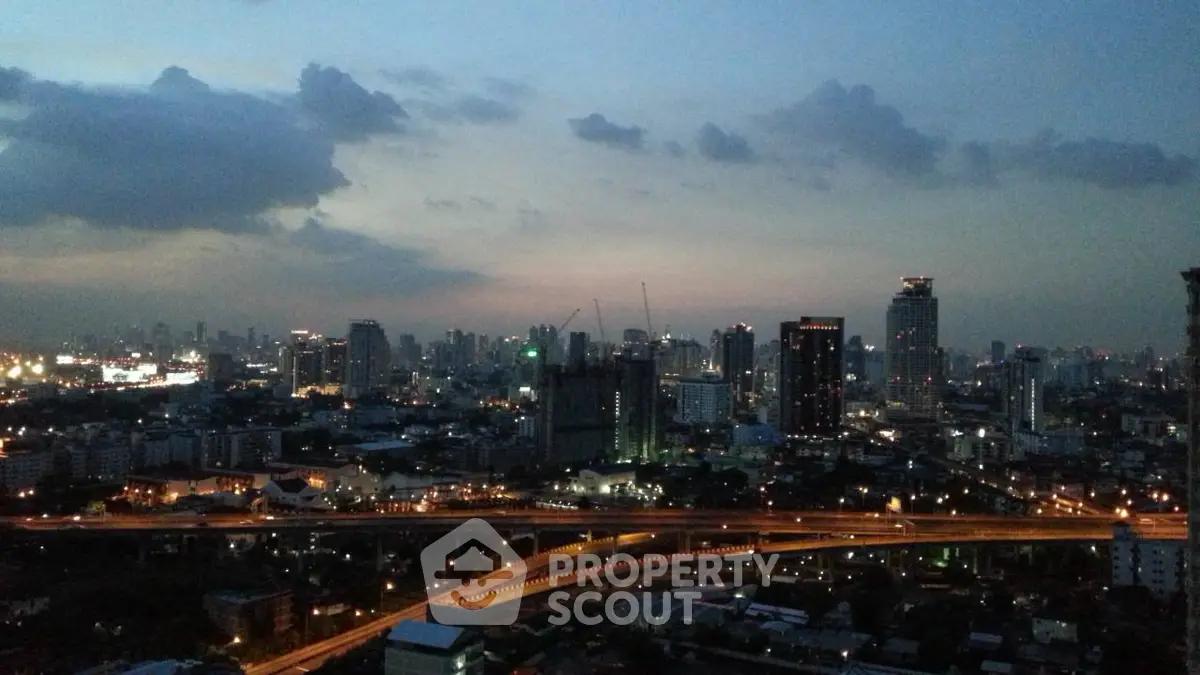 Stunning cityscape view showcasing urban skyline at dusk with illuminated buildings and highways.