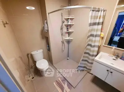Modern bathroom with shower, toilet, and vanity in sleek design