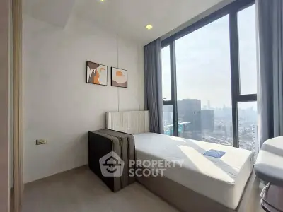 Modern bedroom with city view, featuring sleek design and large windows for natural light.