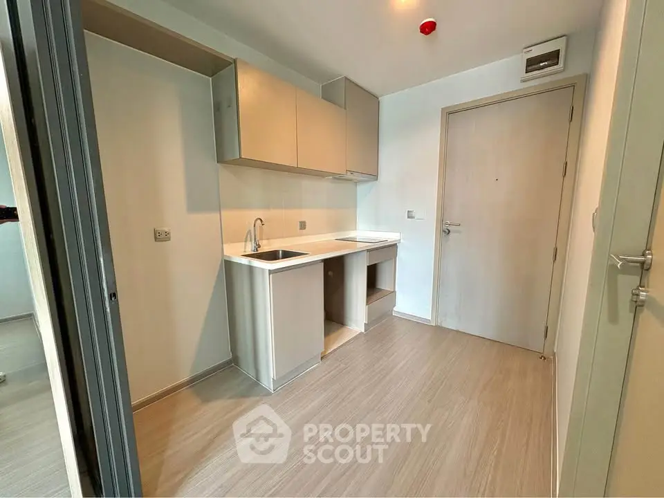 Modern minimalist kitchen with sleek cabinetry and wood flooring