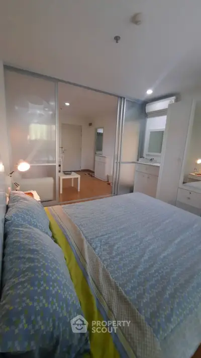 Cozy bedroom with modern decor and ample natural light, featuring a comfortable bed and stylish furnishings.