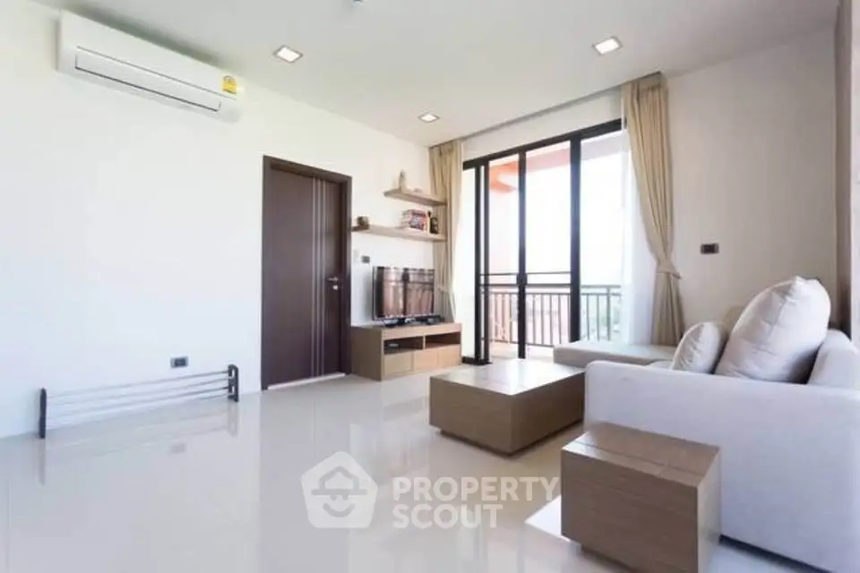Modern living room with sleek furniture and balcony view