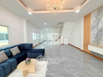 Spacious modern living room with elegant chandelier and stylish decor