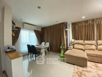 Spacious living room with elegant curtains and cozy seating area