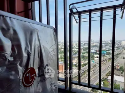 Stunning high-rise balcony view with cityscape and highway, featuring a modern LG appliance.