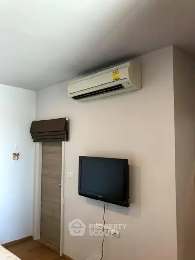Modern interior with air conditioning and wall-mounted TV in a cozy living space.