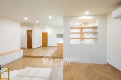Spacious modern living room with open layout and elegant wood flooring