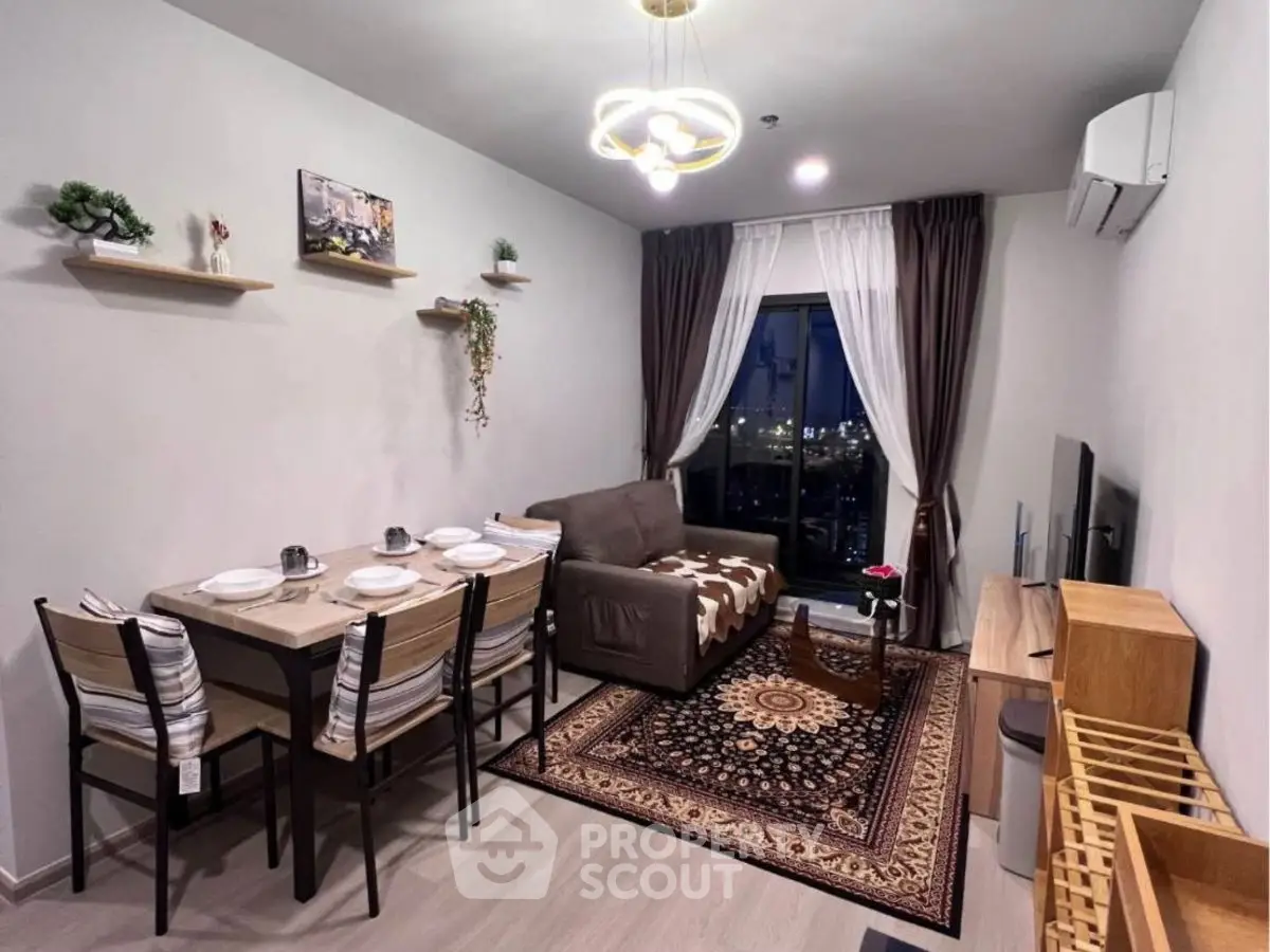 Modern living room with stylish decor and dining area, featuring a cozy sofa and elegant lighting.