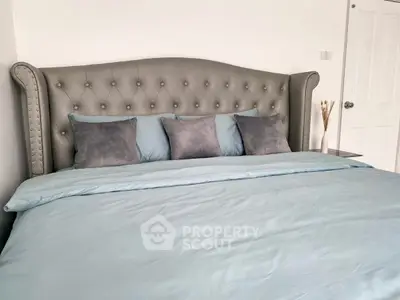 Luxurious bedroom with elegant tufted headboard and plush bedding