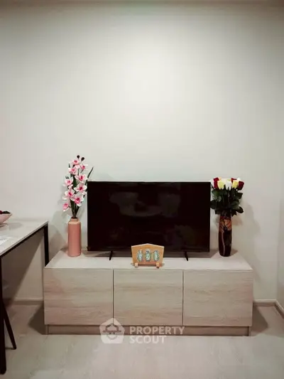 Modern living room with sleek TV stand and elegant floral decor