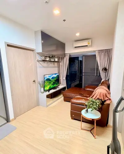 Modern living room with leather sofa and wall-mounted TV, featuring cozy decor and natural light.