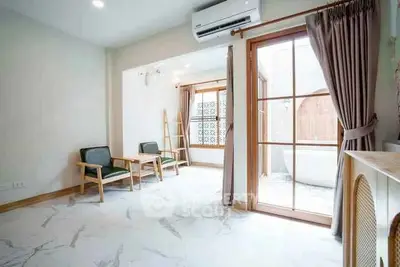 Bright living room with modern furniture and large windows in a stylish apartment.