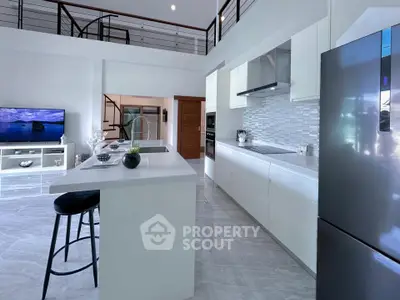 Modern open-layout kitchen with sleek appliances and stylish island seating.