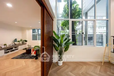 Stylish modern living room with large windows and elegant wooden flooring