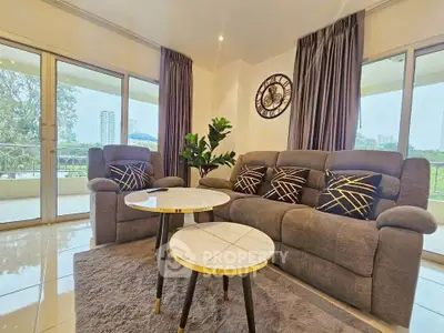 Spacious living room with modern decor and large windows offering scenic views.