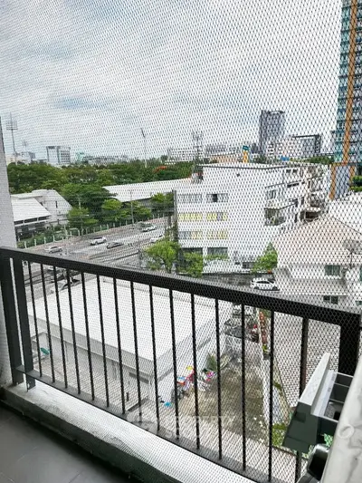 Urban balcony view with cityscape and greenery, perfect for modern living.