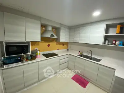 Modern kitchen with sleek cabinetry and built-in appliances