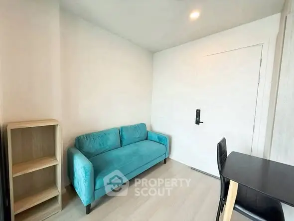 Modern living room with teal sofa and minimalist decor