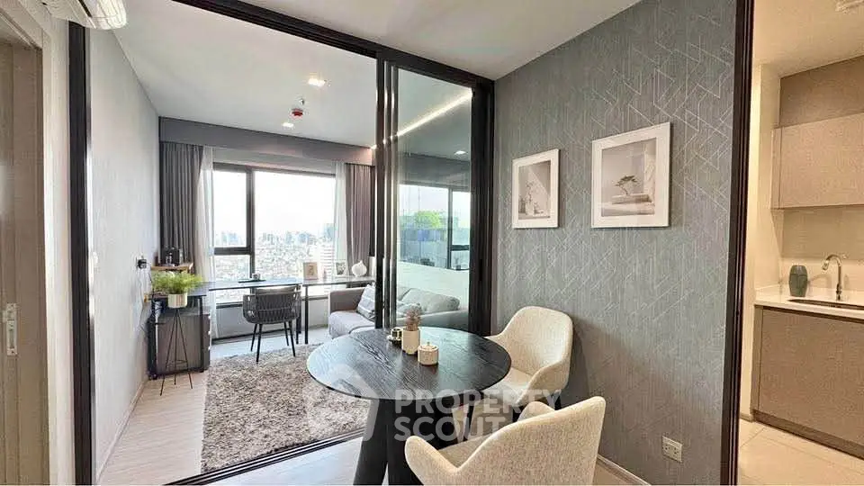 Modern apartment with open living and dining area, featuring stylish decor and city view.