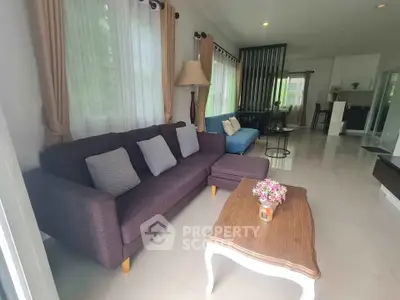 Spacious living room with modern furniture and natural light in a stylish home.