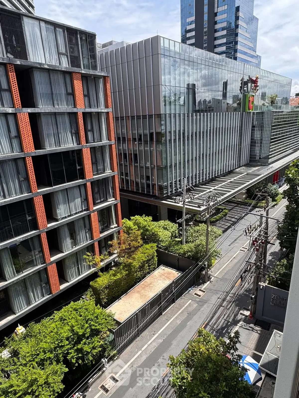 Modern urban view with contemporary buildings and lush greenery in a vibrant cityscape.