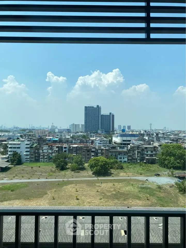 Stunning cityscape view from a high-rise building window showcasing urban skyline and clear blue sky.
