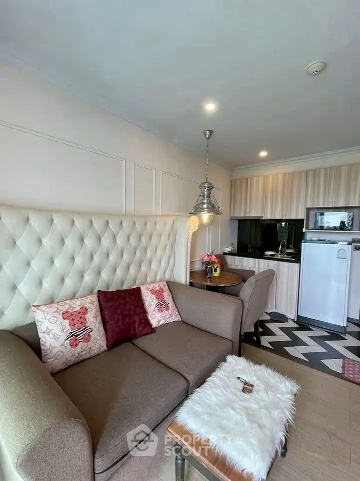 Chic living room with cozy sofa and modern kitchen in stylish apartment