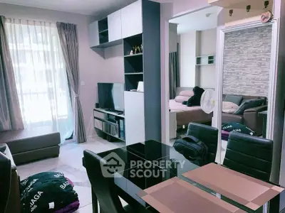 Modern living room with dining area and cozy bedroom in open layout apartment