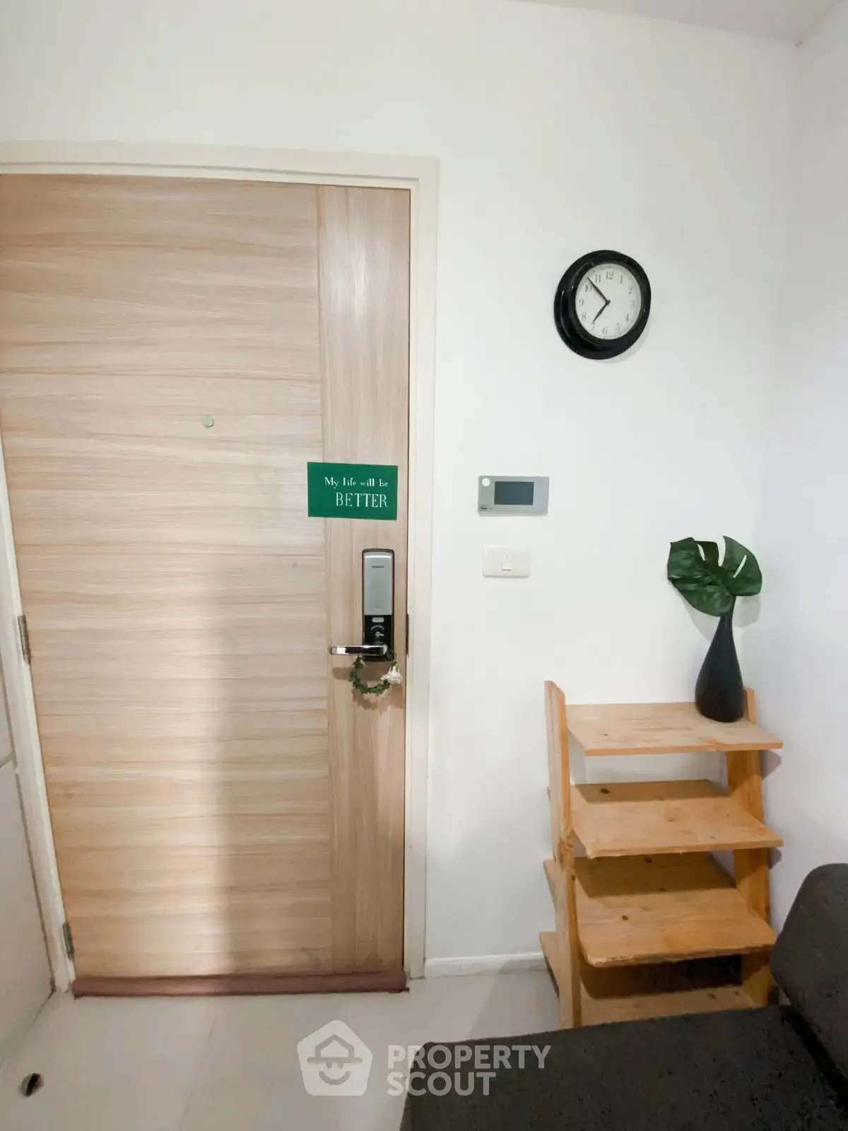 Cozy apartment entrance with wooden door and stylish decor