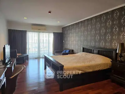 Spacious bedroom with elegant decor and natural light