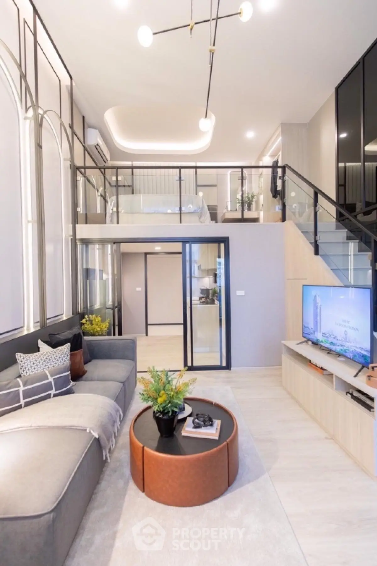 Modern duplex living room with stylish decor and mezzanine bedroom