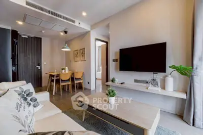 Modern living room with stylish decor and open dining area, perfect for urban living.