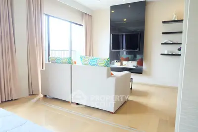 Modern living room with stylish decor and large windows offering natural light.