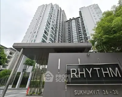 Modern high-rise condominium building with sleek entrance at Rhythm Sukhumvit 36-38.
