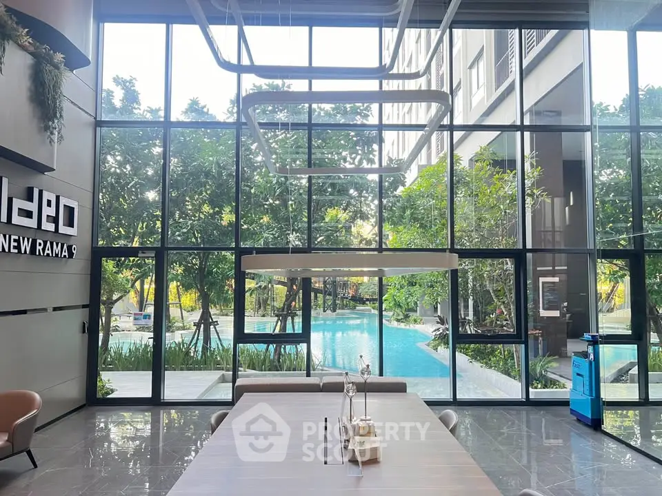 Modern building lobby with pool view and stylish interior design