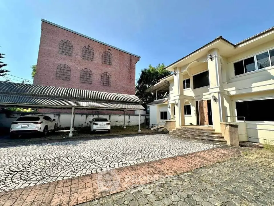 Spacious residential property with ample parking and unique architectural design.