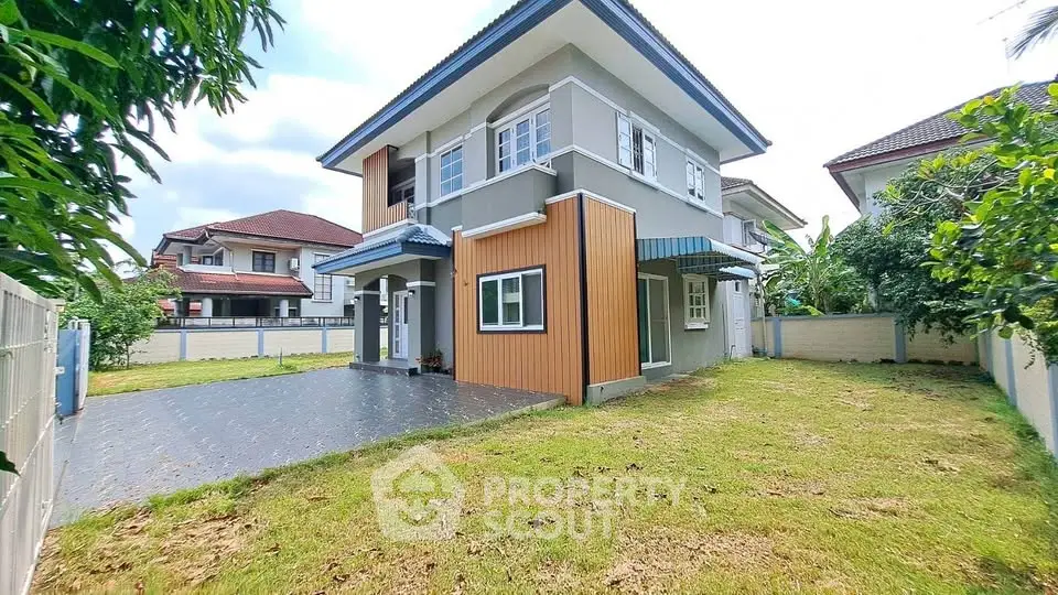 Spacious two-story house with modern design and lush green yard in a serene neighborhood.