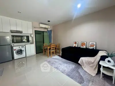 Modern open-plan living room with kitchen, dining area, and stylish decor