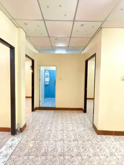 Spacious apartment hallway with tiled flooring and access to multiple rooms
