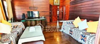 Charming rustic living room with wooden walls and cozy seating area, perfect for relaxation and entertainment.