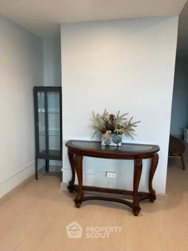 Elegant hallway with classic wooden console table and decorative vase, perfect for stylish home entry.