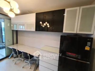 Modern kitchen with sleek cabinetry and stylish lighting in a contemporary apartment.