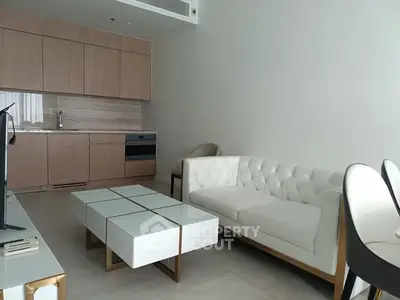 Modern living room with sleek furniture and open kitchen layout