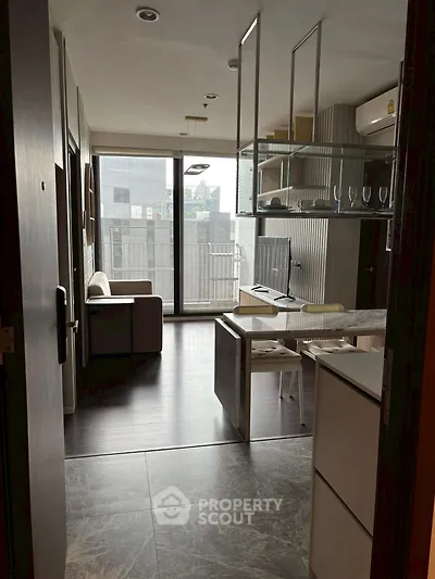 Modern apartment with open layout, stylish furnishings, and large windows offering city views.