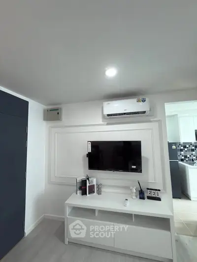Modern living room with wall-mounted TV and air conditioning unit