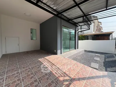 Modern home exterior with covered patio and stylish tile flooring